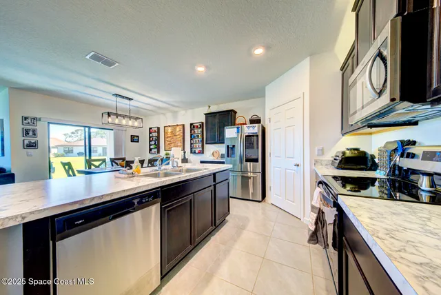 a kitchen with stainless steel appliances granite countertop a sink and stove top oven