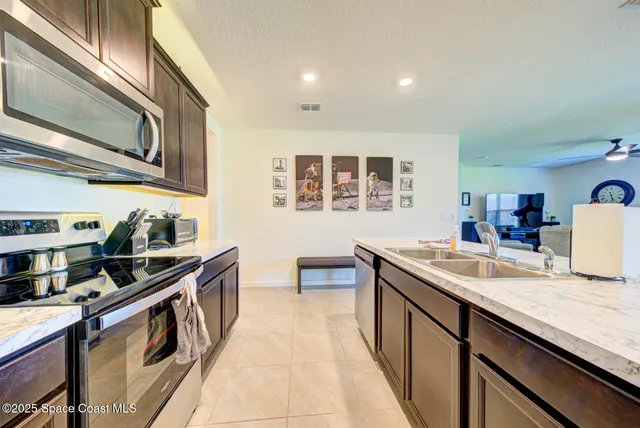 a kitchen with stainless steel appliances granite countertop a sink and stove