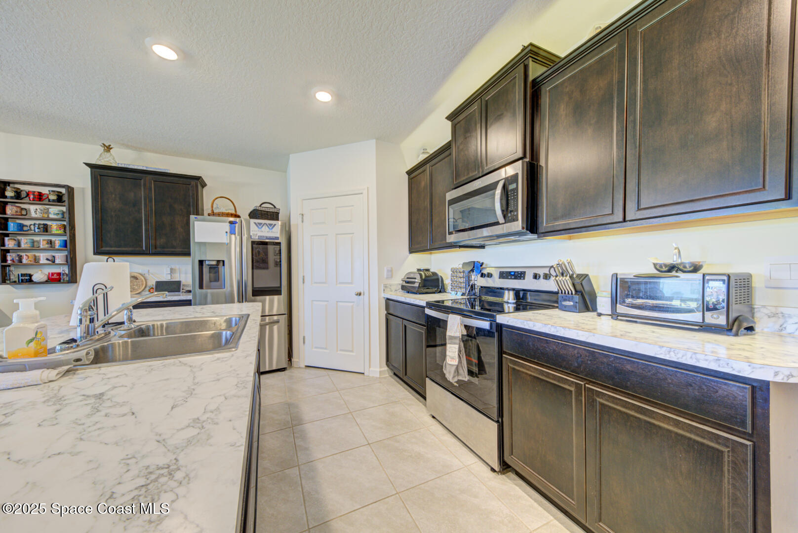 4941 Talbot Boulevard Cocoa, FL 32926 - Photo 20 of 48 a kitchen with granite countertop stainless steel appliances and wooden cabinets