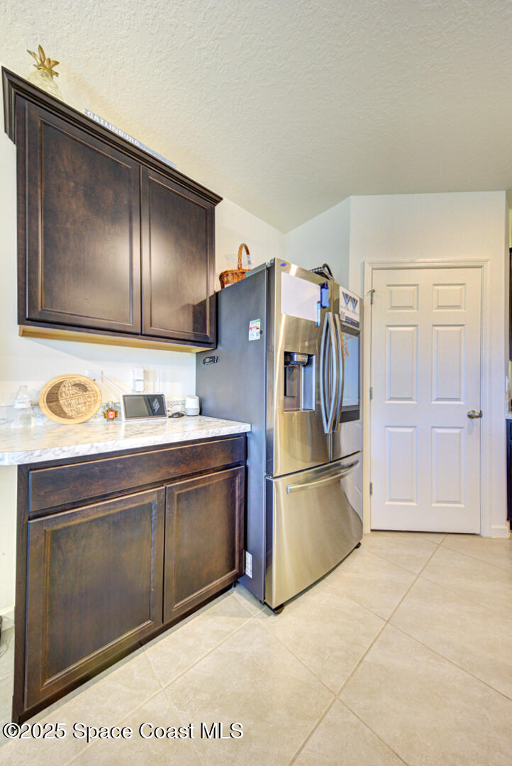 4941 Talbot Boulevard Cocoa, FL 32926 - Photo 21 of 48 a kitchen with stainless steel appliances granite countertop a refrigerator and a stove top oven