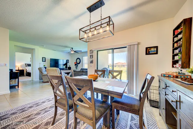 a view of a dining room with furniture and a chandelier