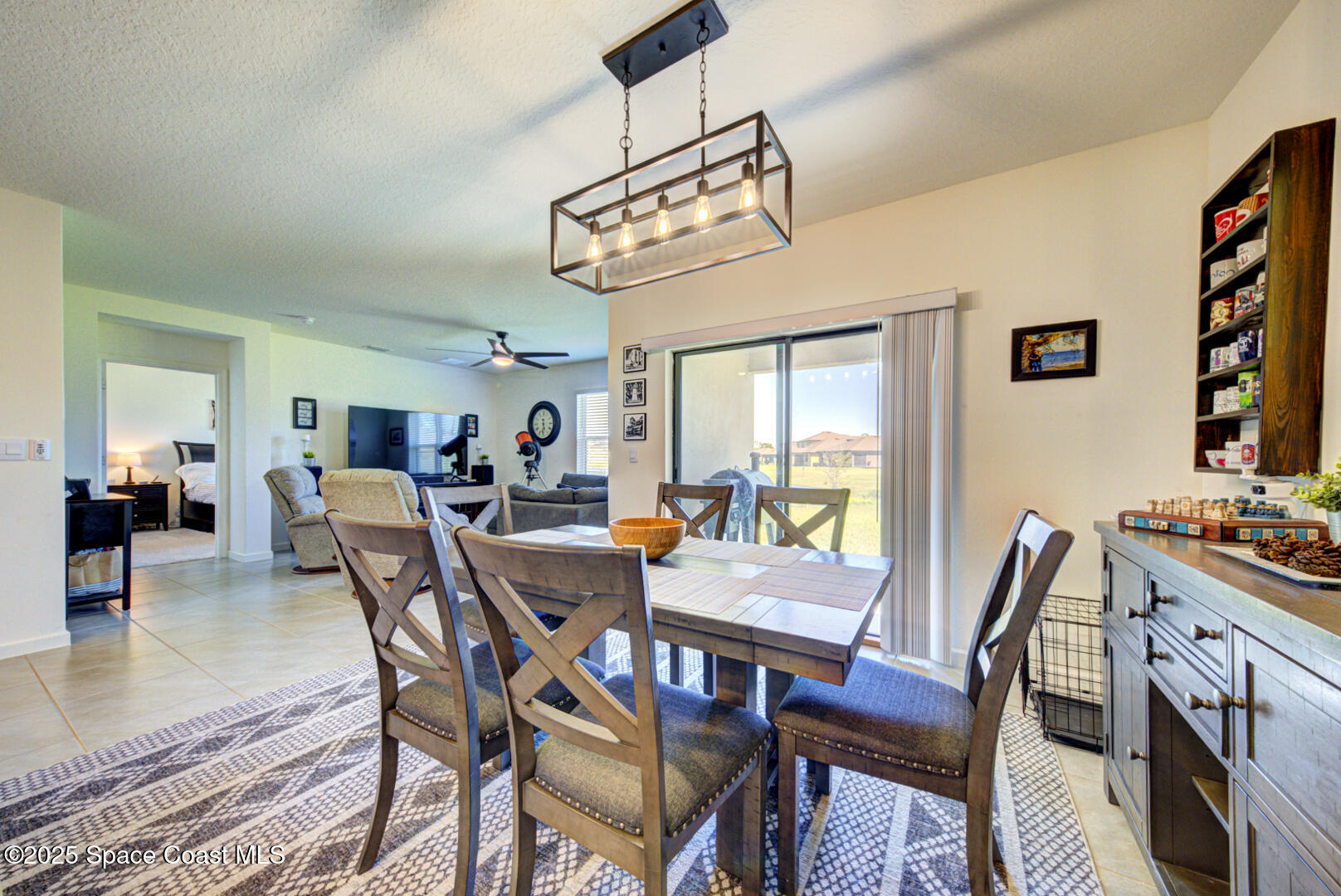4941 Talbot Boulevard Cocoa, FL 32926 - Photo 24 of 48 a view of a dining room with furniture and a chandelier