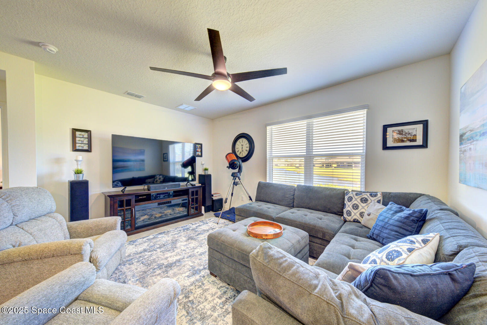 4941 Talbot Boulevard Cocoa, FL 32926 - Photo 26 of 48 a living room with furniture a window and a flat screen tv
