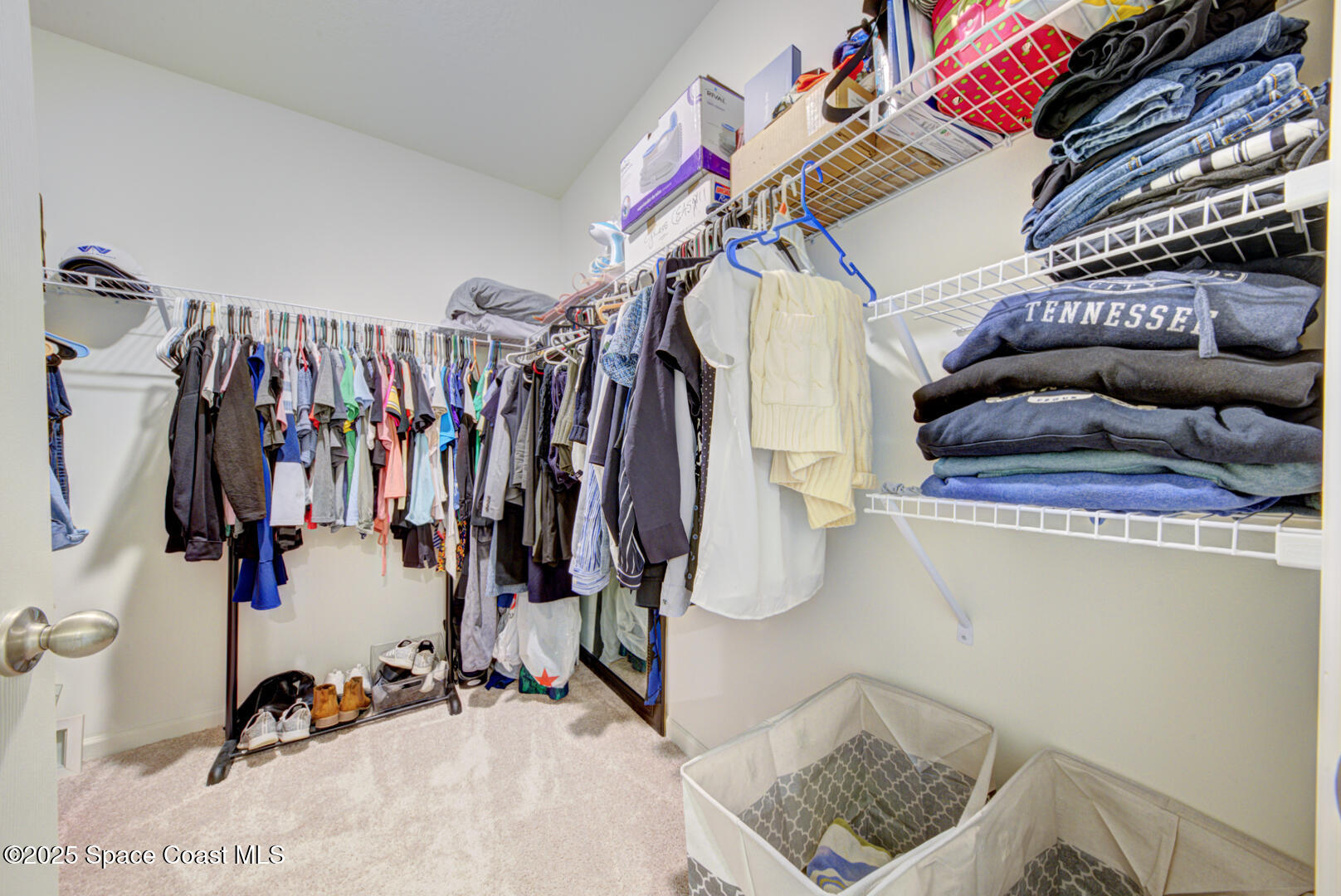 4941 Talbot Boulevard Cocoa, FL 32926 - Photo 31 of 48 a view of walk in closet with clothes and shoes