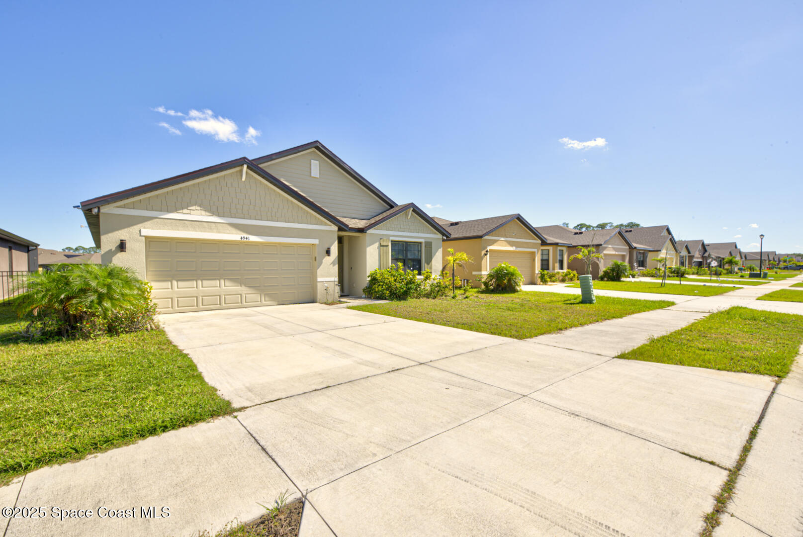 4941 Talbot Boulevard Cocoa, FL 32926 - Photo 42 of 48 a front view of a house with a yard and garage