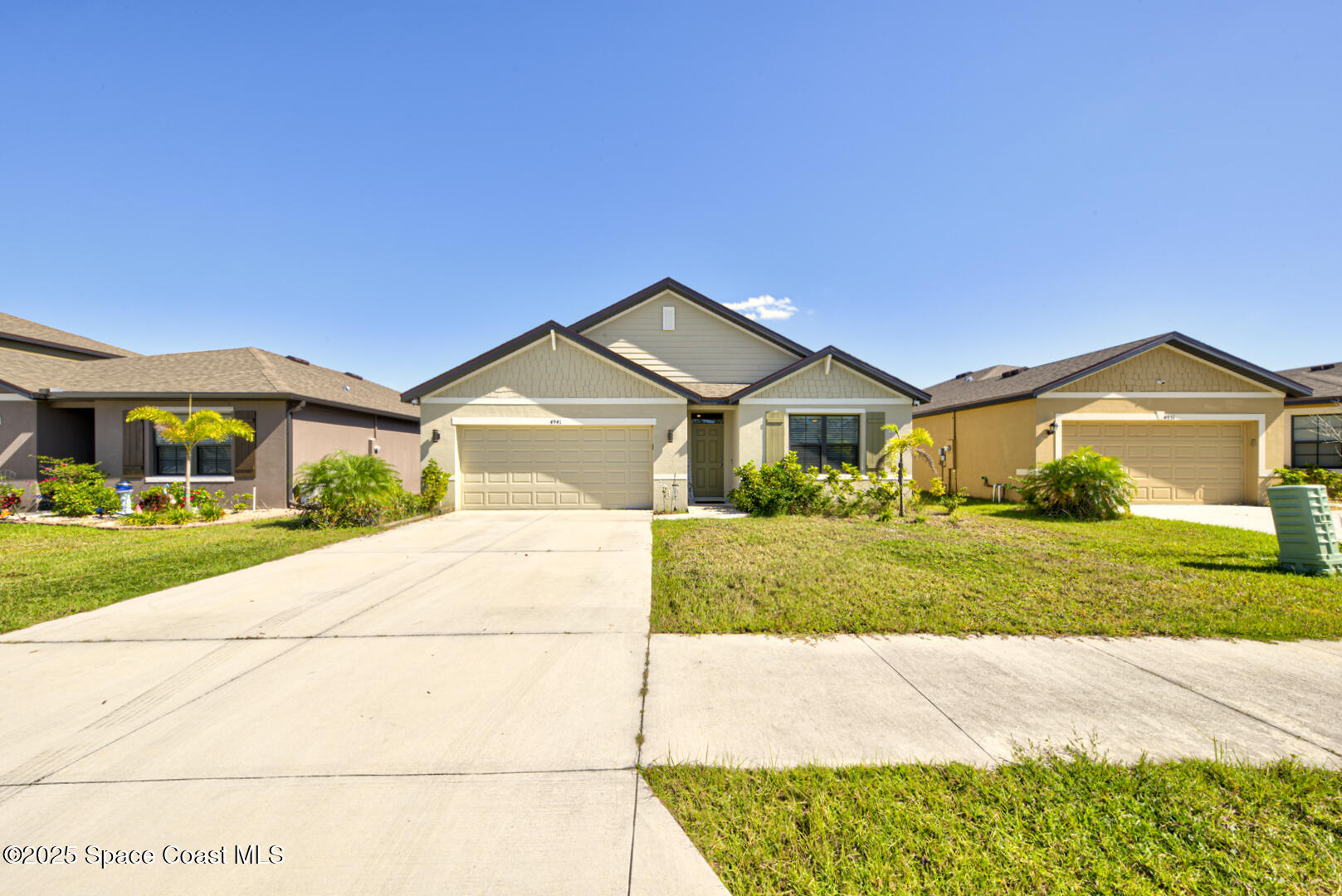 4941 Talbot Boulevard Cocoa, FL 32926 - Photo 44 of 48 a front view of a house with a yard and garage