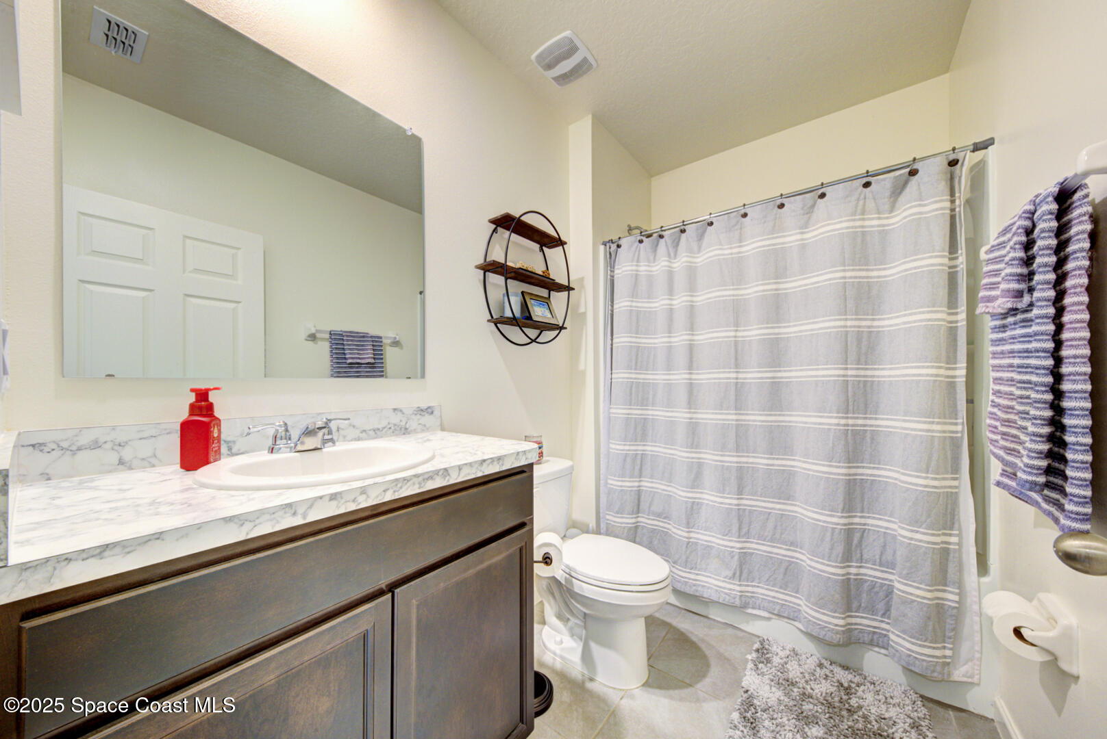 4941 Talbot Boulevard Cocoa, FL 32926 - Photo 6 of 48 a bathroom with a sink and a toilet