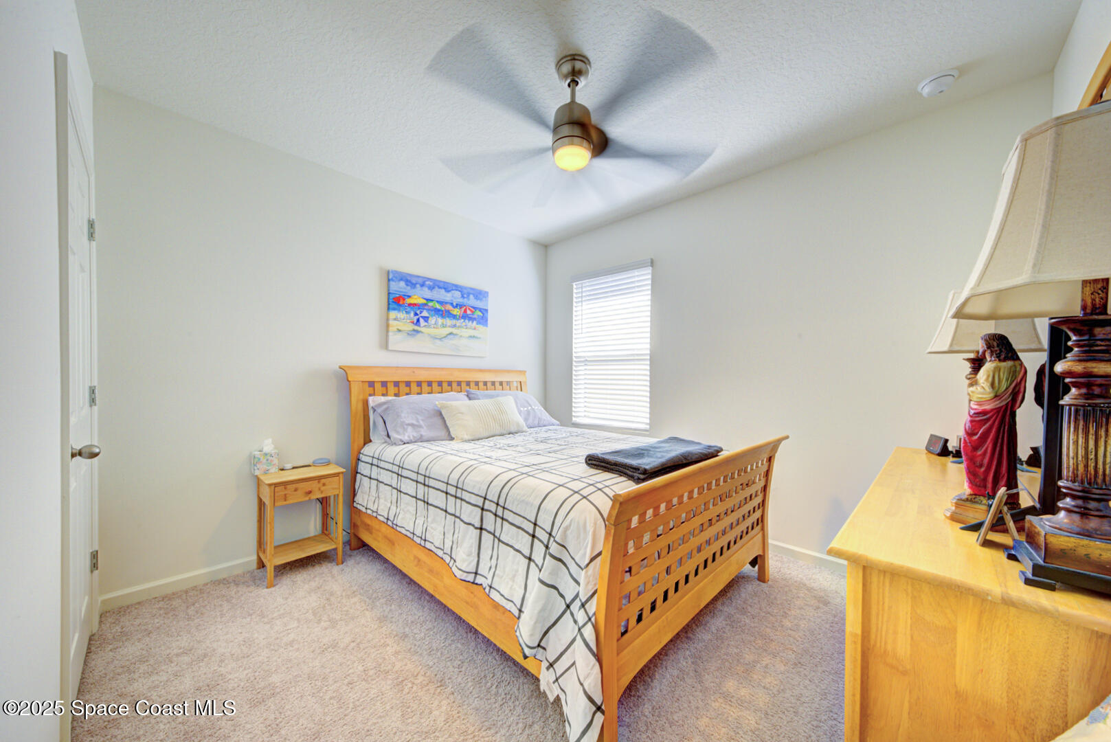 4941 Talbot Boulevard Cocoa, FL 32926 - Photo 7 of 48 a bedroom with a bed and a chandelier