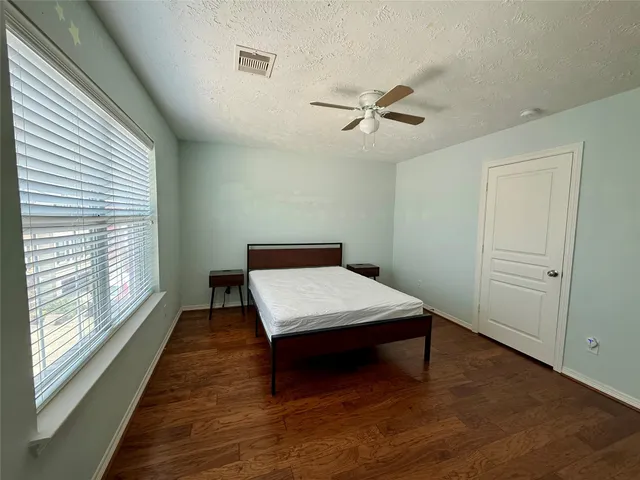 a room with wooden floor and window