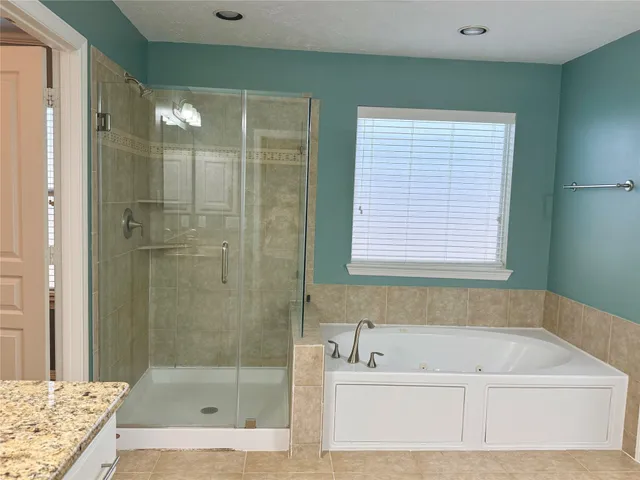 a bathroom with a bathtub and shower