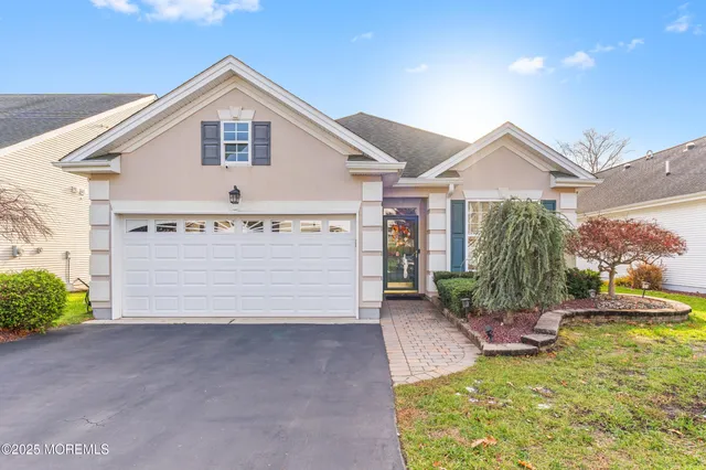 a view of a house with a yard and garage