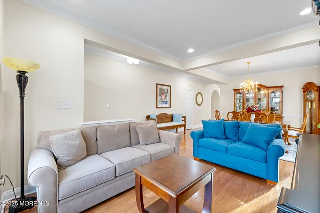 a view of a dining room with furniture and a chandelier