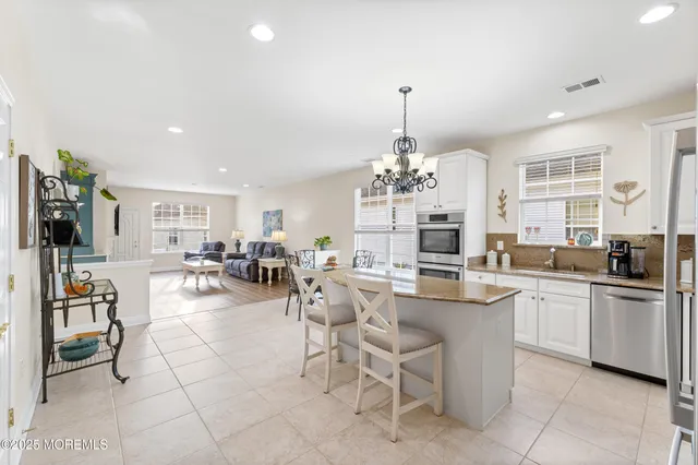 a kitchen with appliances a center island and cabinets