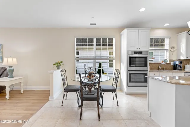 a living room with furniture a dining table and chairs