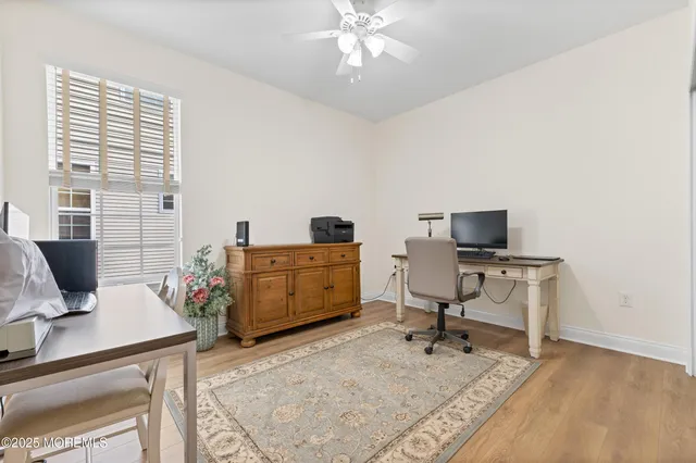 a view of a livingroom with workspace and a couch