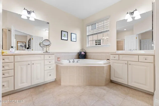 a spacious bathroom with a double vanity sink mirror and double