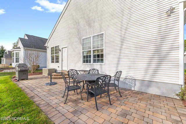 a dining room with furniture a rug and a chandelier