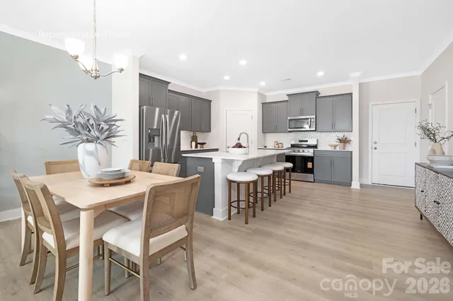 a large kitchen with a table and chairs