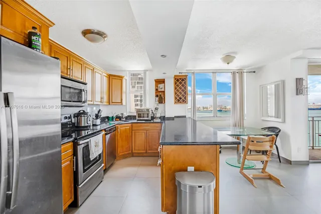 a kitchen with stainless steel appliances granite countertop a stove and a refrigerator