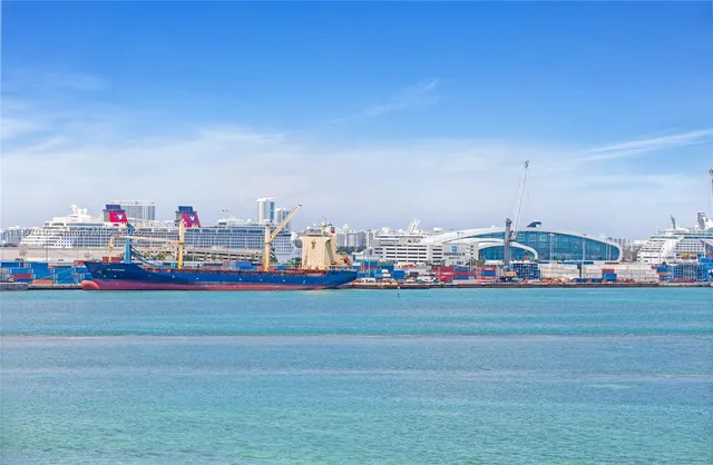 a kitchen with stainless steel appliances granite countertop a refrigerator a stove and a sink