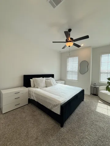 a bedroom with a bed and window