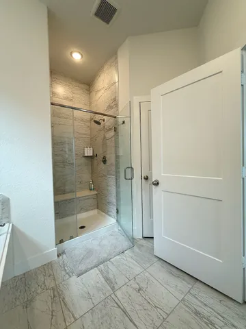 a bathroom with a shower and a sink