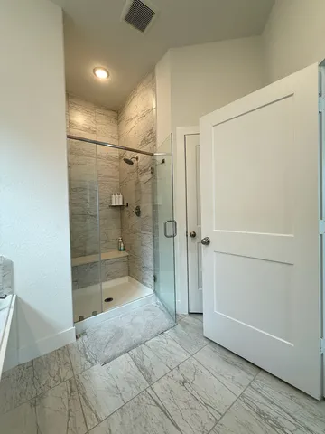a bathroom with a shower and a sink