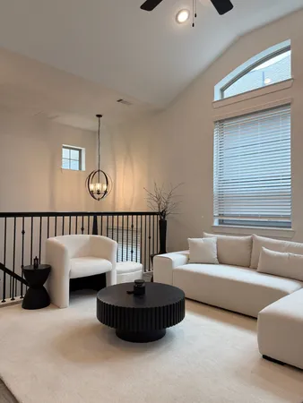 a living room with furniture and a potted plant