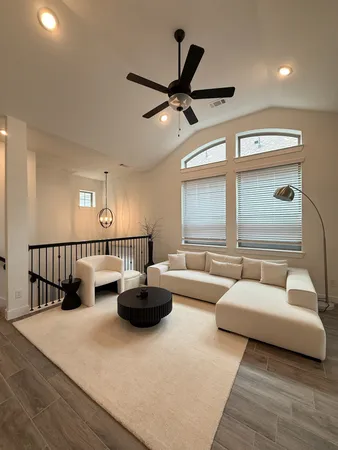 a living room with furniture and a large window