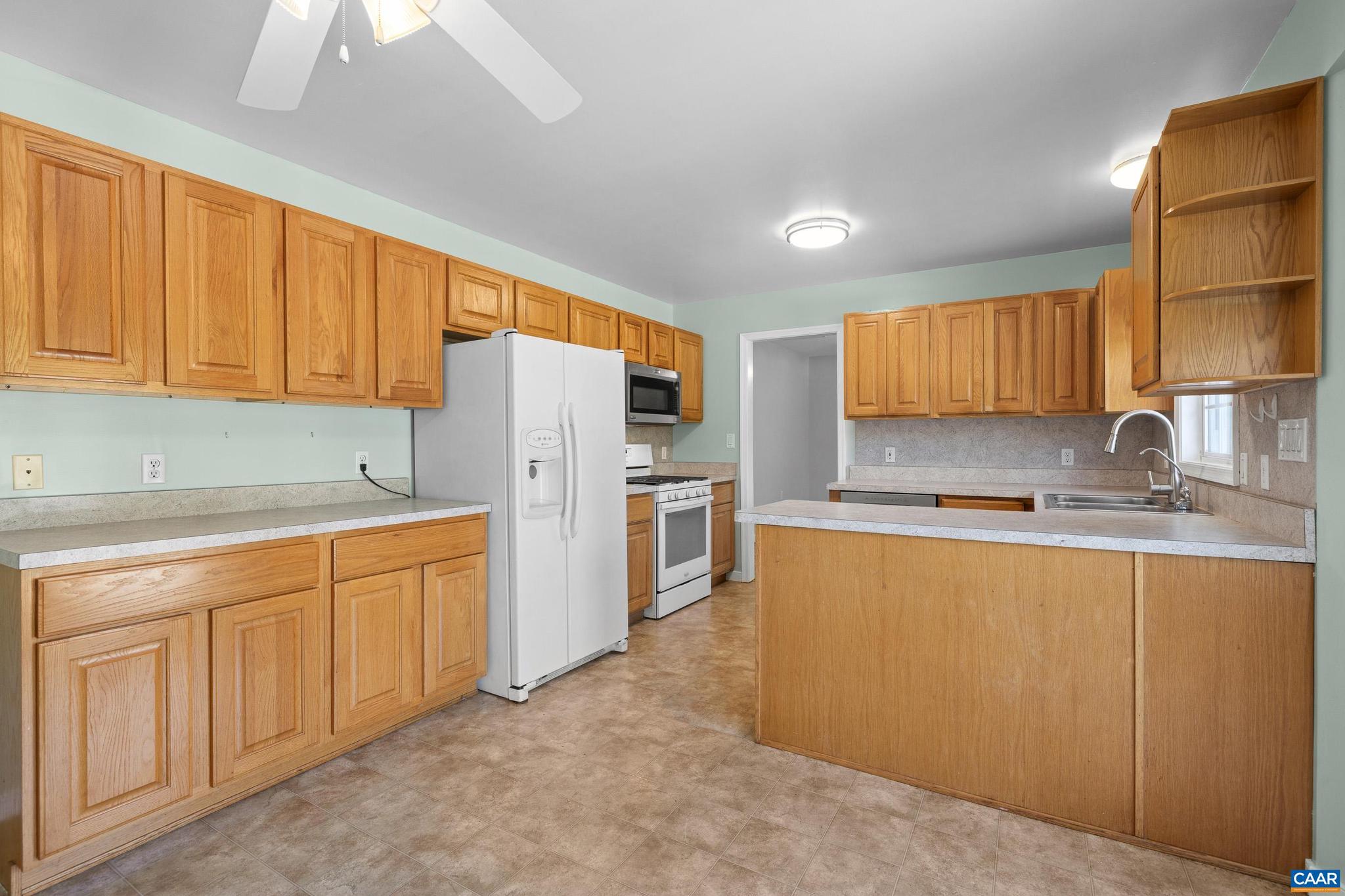 1075 Social Hall Road New Canton, VA 23123 - Photo 59 of 64 a kitchen with stainless steel appliances granite countertop a refrigerator sink and cabinets