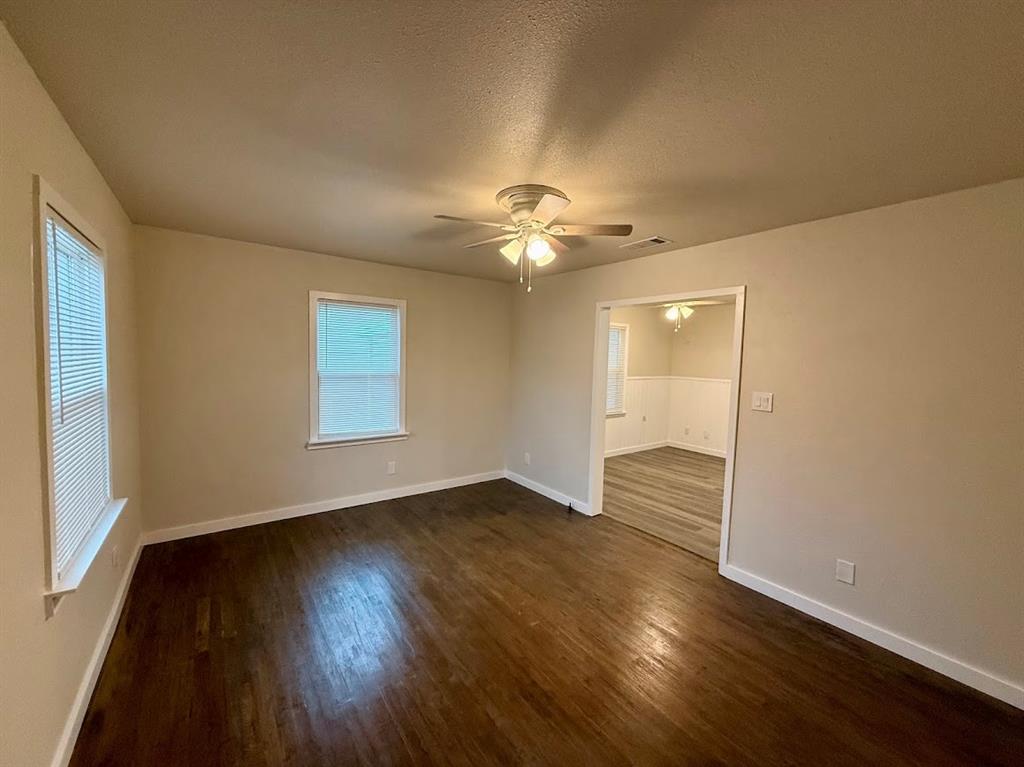 133 Gordon Drive Azle, TX 76020 - Photo 13 of 29 an empty room with wooden floor and windows