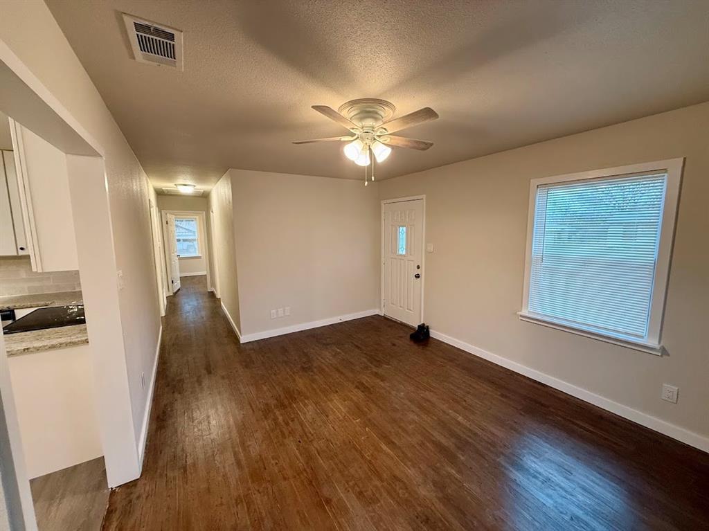 133 Gordon Drive Azle, TX 76020 - Photo 15 of 29 a view of an empty room with window and wooden floor