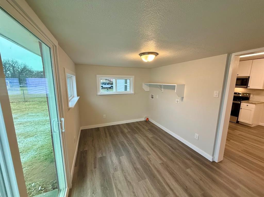 133 Gordon Drive Azle, TX 76020 - Photo 19 of 29 a view of an empty room with wooden floor and a window