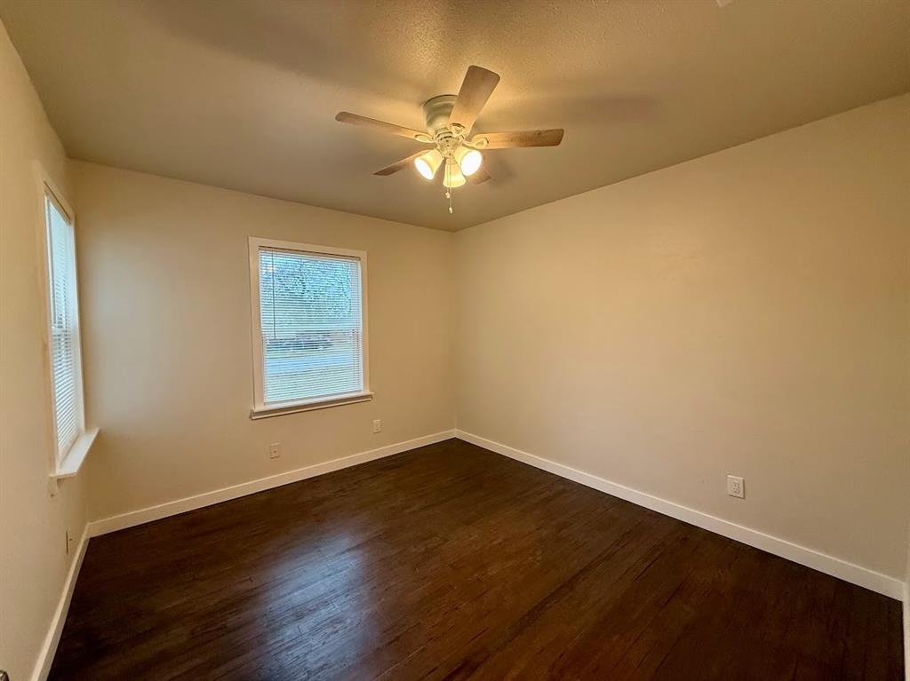 133 Gordon Drive Azle, TX 76020 - Photo 24 of 29 a view of an empty room with wooden floor and a window