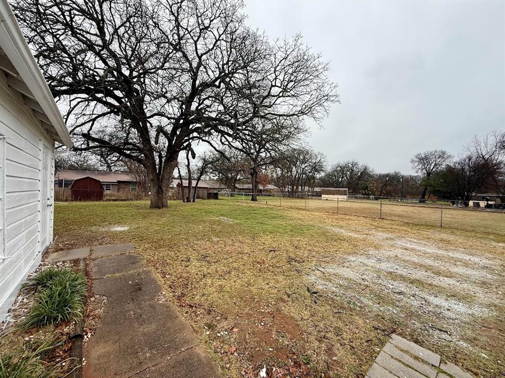 133 Gordon Drive Azle, TX 76020 - Photo 5 of 29 a view of a yard with plants and large trees