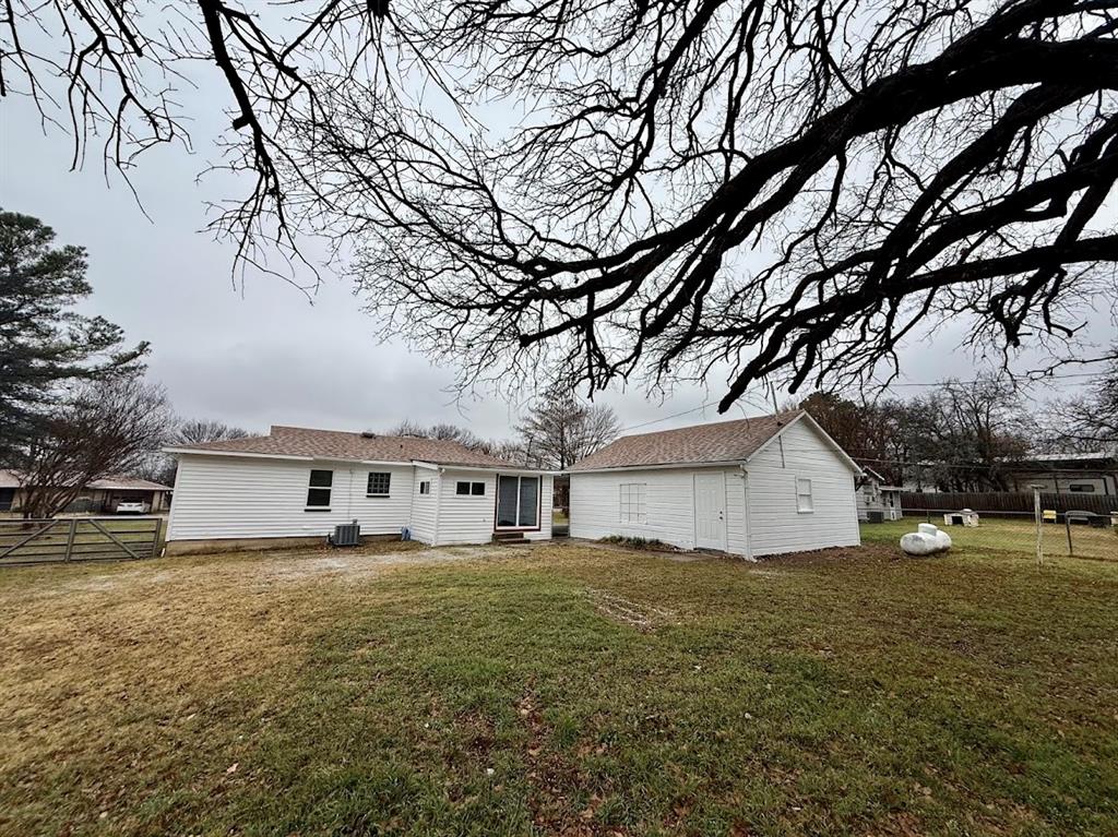 133 Gordon Drive Azle, TX 76020 - Photo 8 of 29 a large white house with a big yard and large trees