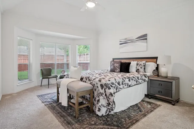 a spacious en suite bathroom with a granite countertop sink mirror and shower
