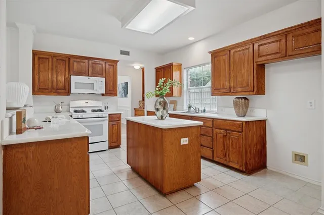 a kitchen with stainless steel appliances granite countertop a stove sink and cabinets