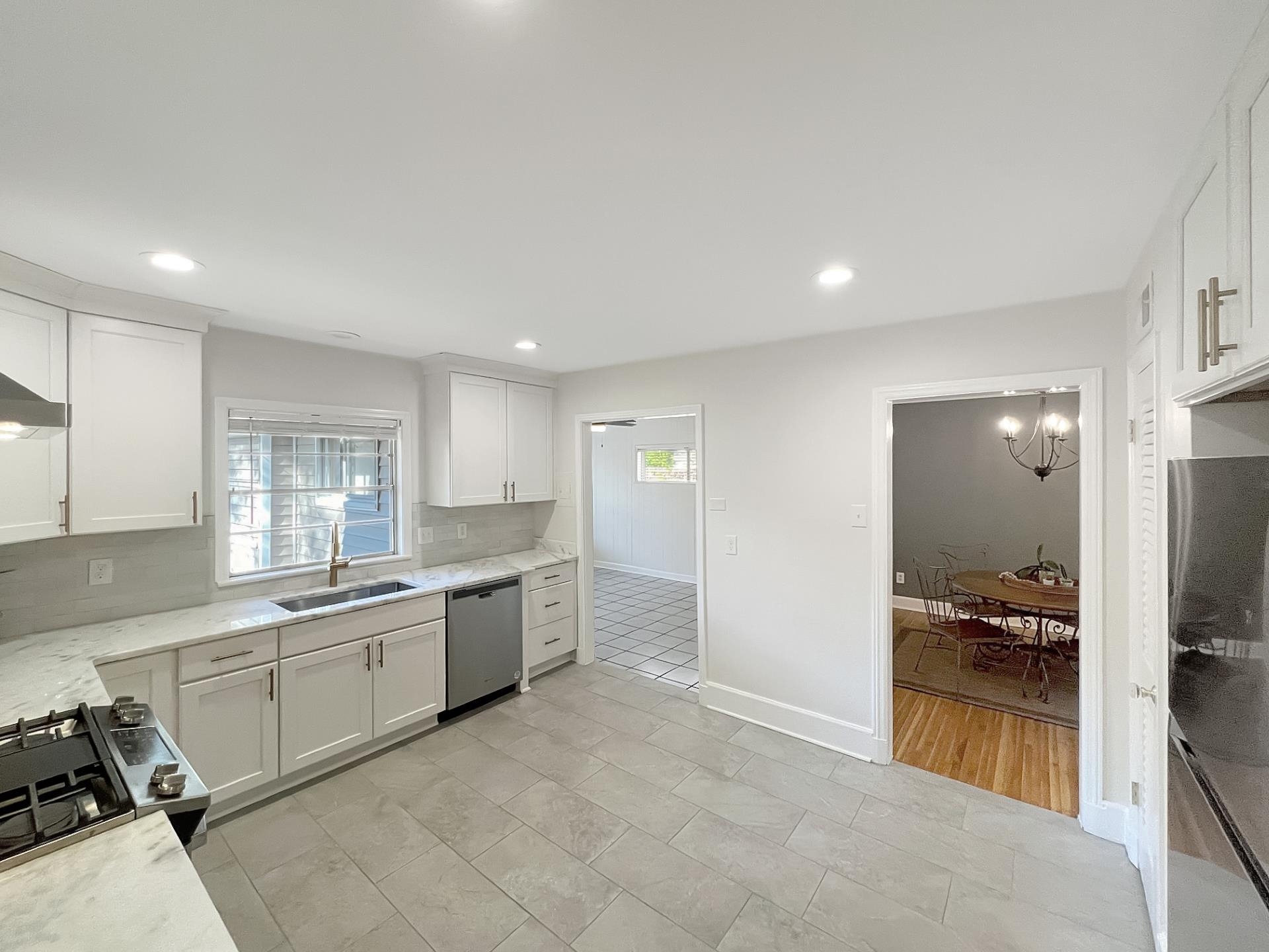 1049 South Perkins Road Memphis, TN 38117 - Photo 11 of 23 a large white kitchen with a sink and cabinets