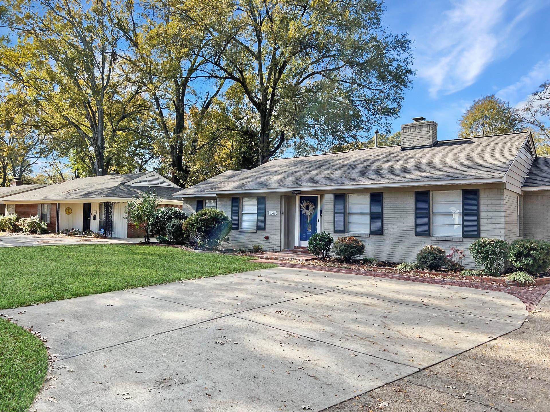1049 South Perkins Road Memphis, TN 38117 - Photo 2 of 23 a front view of a house with yard patio and green space