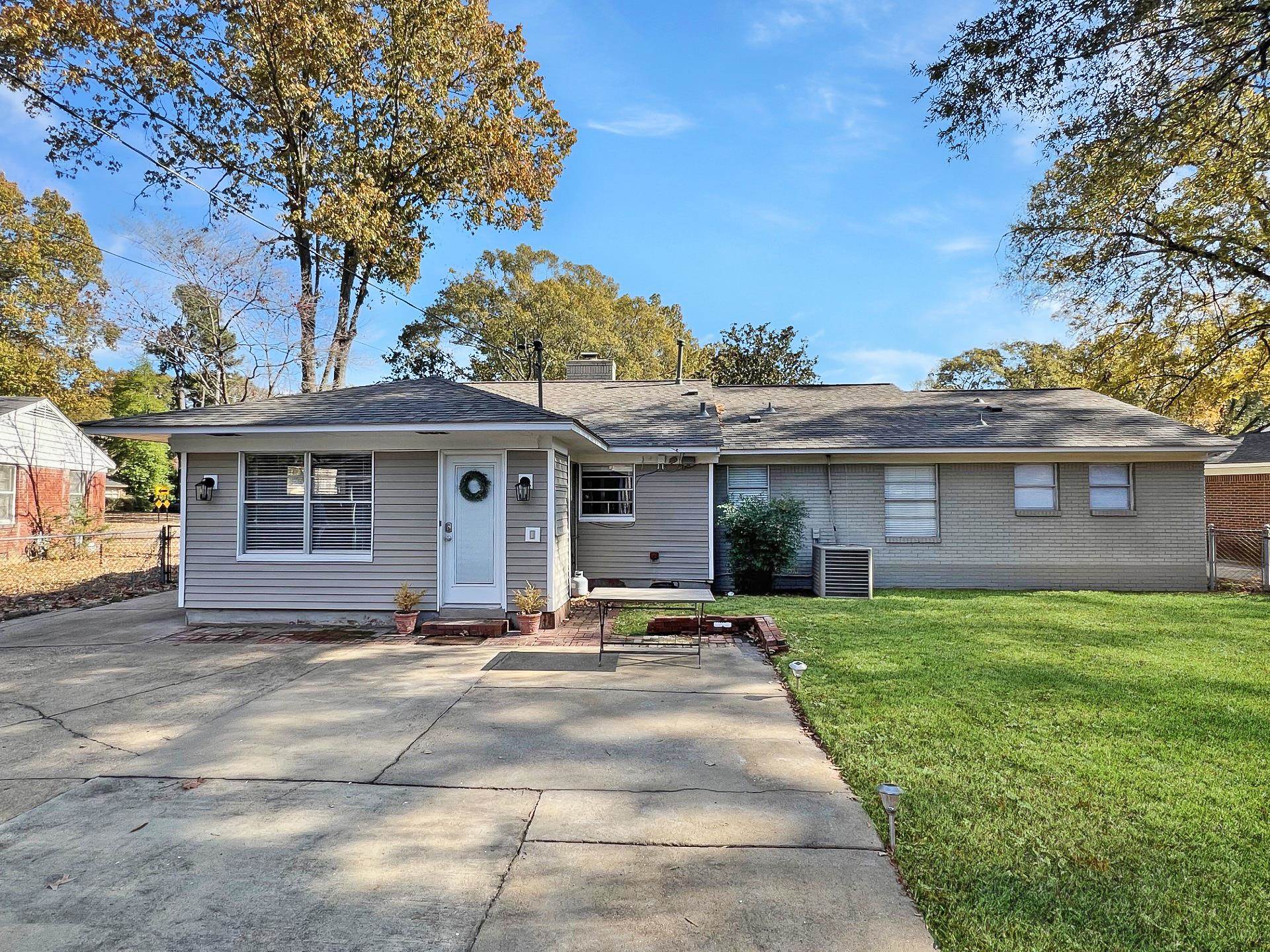 1049 South Perkins Road Memphis, TN 38117 - Photo 3 of 23 a front view of a house with a garden and trees