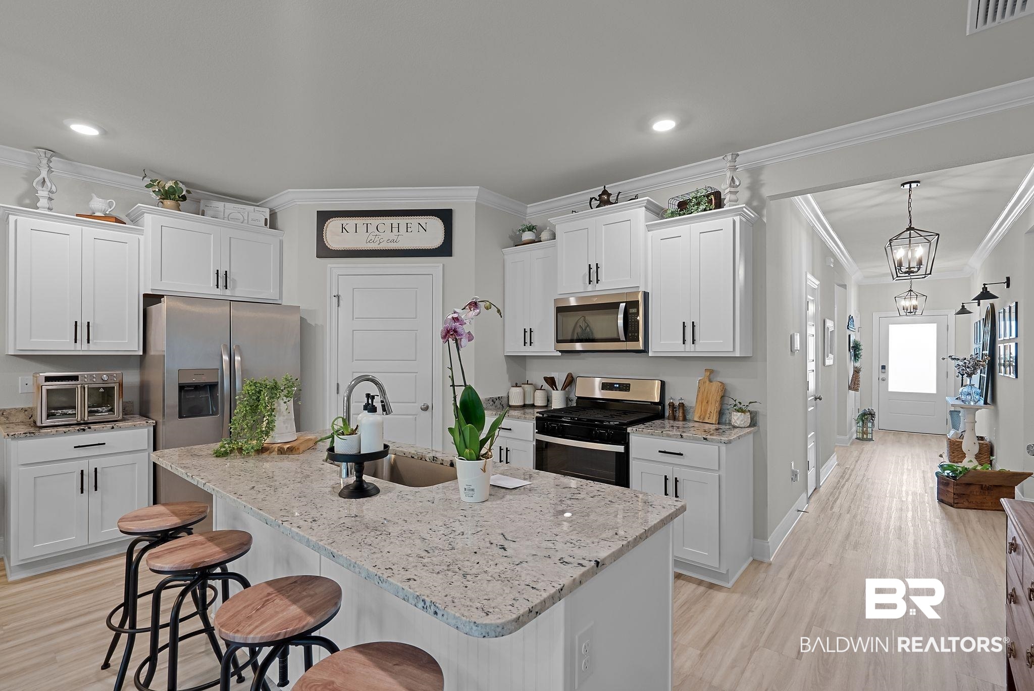 13966 Antler Hl Road Daphne, AL 36527 - Photo 5 of 44 Kitchen featuring white shaker cabinetry, stainless steel appliances, and light-toned granite countertops