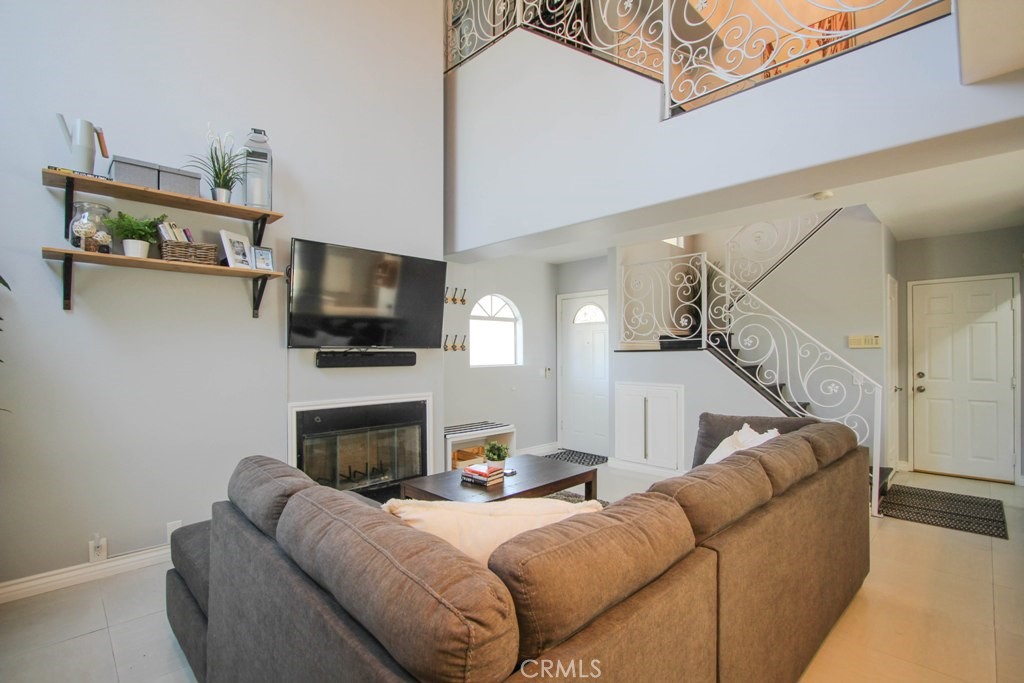 1920 Maple Avenue, Unit A Costa Mesa, CA 92627 - Photo 11 of 35 a living room with furniture a flat screen tv and a fireplace