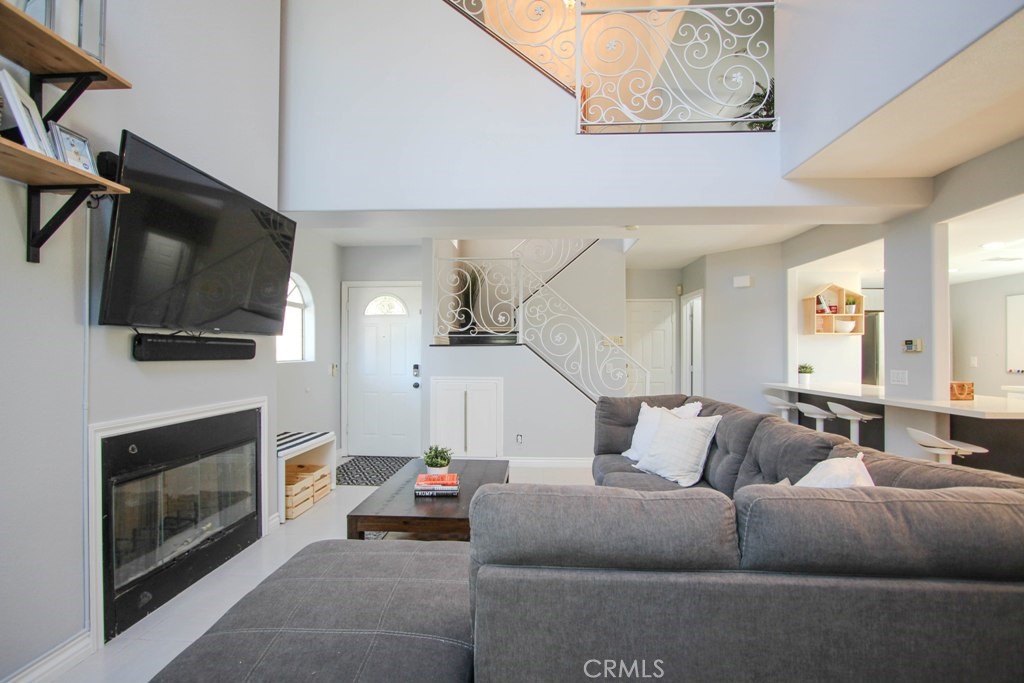 1920 Maple Avenue, Unit A Costa Mesa, CA 92627 - Photo 12 of 35 a living room with furniture a fireplace and a flat screen tv