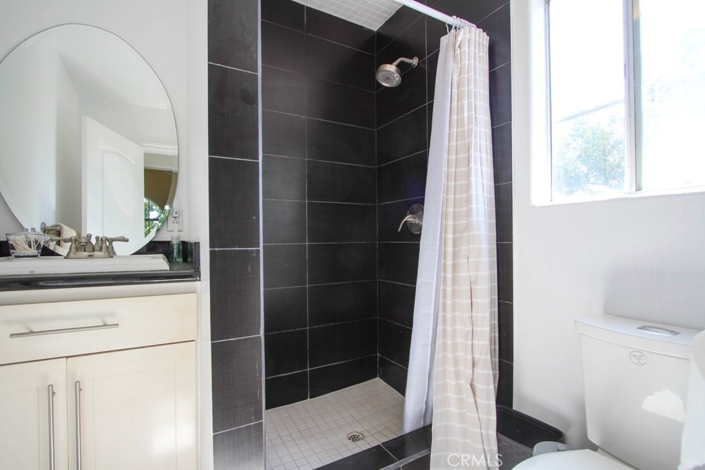 1920 Maple Avenue, Unit A Costa Mesa, CA 92627 - Photo 26 of 35 a bathroom with a shower and a sink
