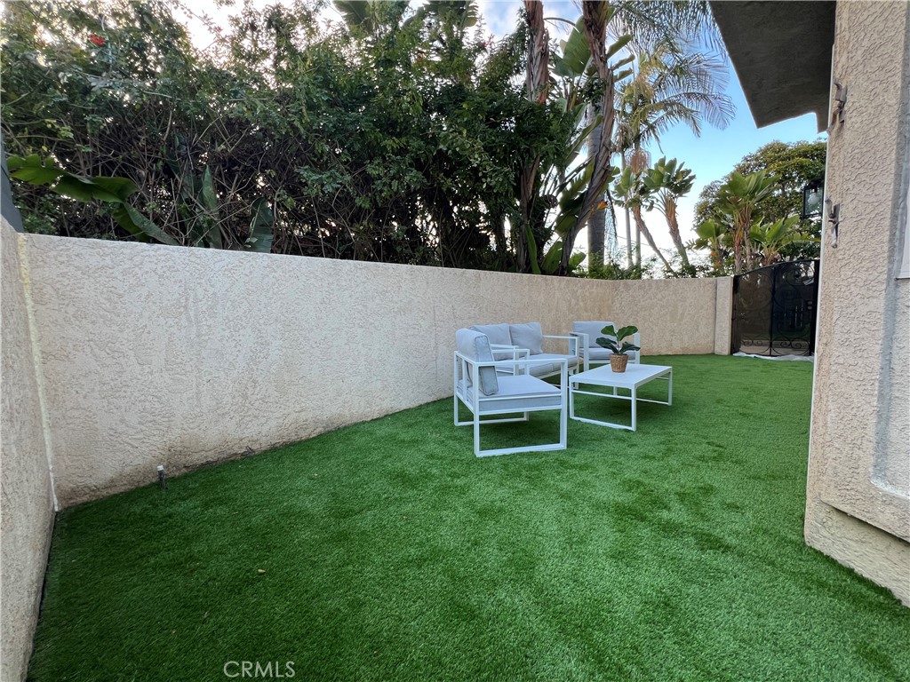 1920 Maple Avenue, Unit A Costa Mesa, CA 92627 - Photo 34 of 35 a backyard of a house with table and chairs