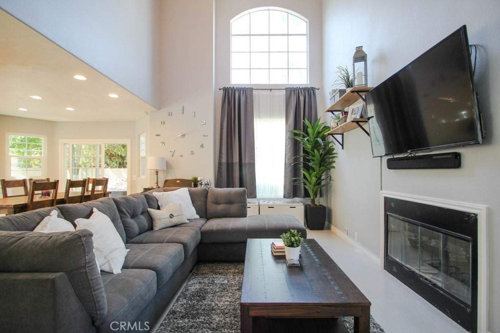1920 Maple Avenue, Unit A Costa Mesa, CA 92627 - Photo 7 of 35 a living room with fireplace furniture and a flat screen tv