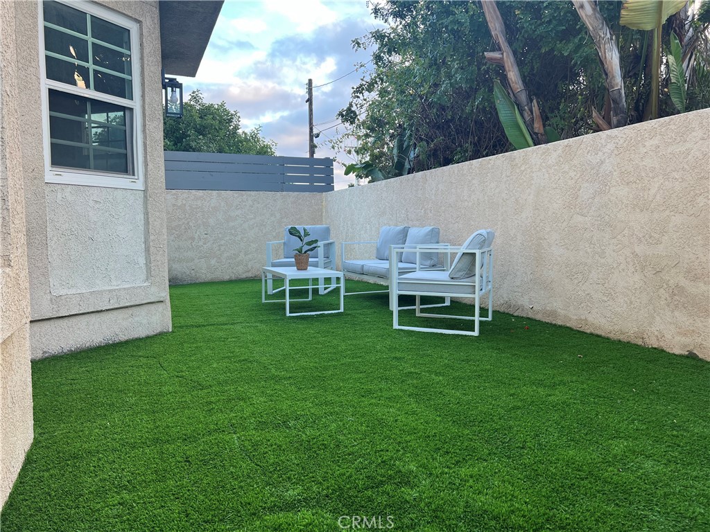 1920 Maple Avenue, Unit A Costa Mesa, CA 92627 - Photo 8 of 35 a backyard of a house with table and chairs