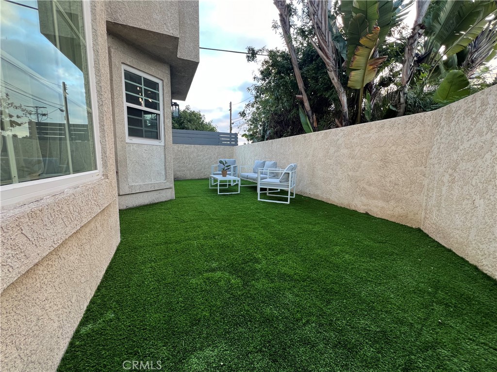 1920 Maple Avenue, Unit A Costa Mesa, CA 92627 - Photo 9 of 35 a view of backyard with a white house and wooden fence