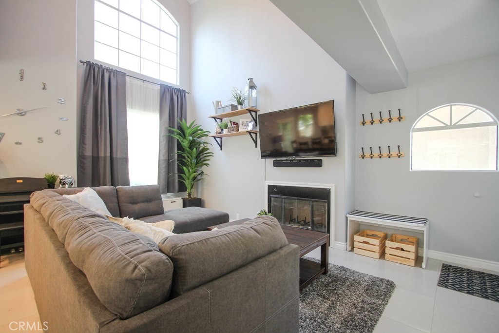 1920 Maple Avenue, Unit A Costa Mesa, CA 92627 - Photo 10 of 35 a living room with furniture a fireplace and a flat screen tv